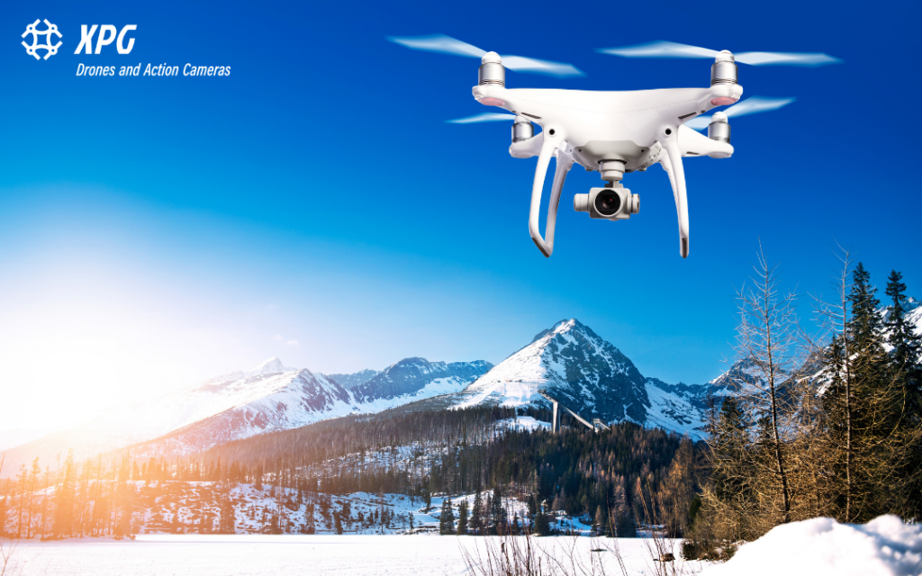 A camera for drones. A drone flying over a mountain region for aerial photography.