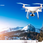 A camera for drones. A drone flying over a mountain region for aerial photography.