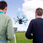 This image shows professional drone pilots flying a drone.